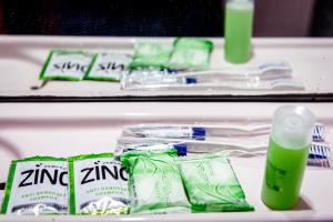 a shelf with toothbrushes and green toothpaste at Melin Hotel Tanjungpinang in Tanjung Pinang +19 photos