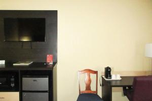 a chair sitting in front of a desk with a computer at Quality Inn & Suites in Benton Harbor
