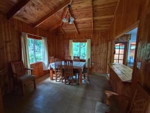 a dining room with a table and chairs at Cabaña Leandro Lago Panguipulli in Panguipulli +13 photos