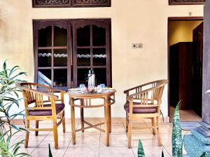 a table and two chairs on a patio at Wirya House in Ubud