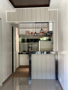 a kitchen with a counter in a room at The Roam Inn - Fast Wifi Connection in Dipolog