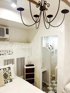 a bedroom with a bed and a chandelier at Lugar Bonito Hotel in Boracay +140 photos