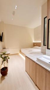 ジョージタウンにあるKazuki Boutique Accommodationのベッド1台とシンク付きの広い客室です。 +16枚の写真