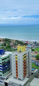 a view of a building with the ocean in the background at Ilusion Vista Mar JR 1207 in Natal