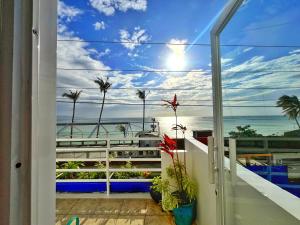 a balcony with a cruise ship in the ocean at Lugar Bonito Hotel in Boracay