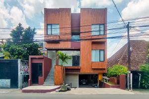 a red building with stairs in front of it at Sans Hotel Bogor in Bogor