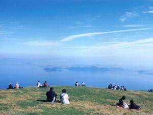 a group of people sitting on top of a hill at Lake Biwa Otsu Prince Hotel in Otsu +184 photos