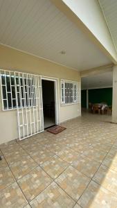 an empty room with an open door and a table at Casa Beija Flor in Novo Airão