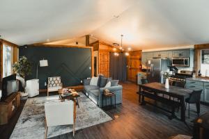 a living room with a couch and a table at Log Cabin with King Bed and Hot Tub in Ashford
