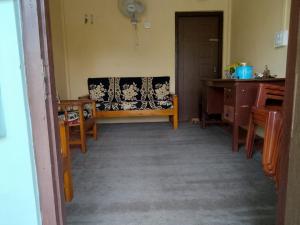 a living room with a couch and a table at Pt khongknaw homestay in Mawlynnong