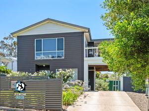 a house with a fence in front of it at Modern Coastal with Sparkling Sea Views in Victor Harbor in Victor Harbor