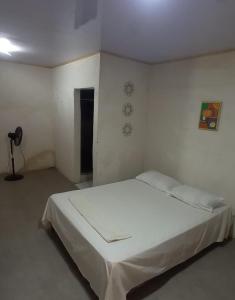 a bedroom with a white bed in a room at Hostal Brisas del Ometepe Habitación 3 in Rivas