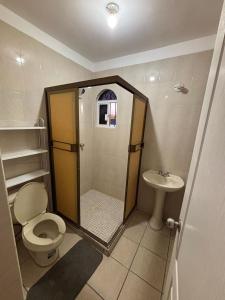 a bathroom with a shower and a toilet and a sink at Casa Montebello in Los Mochis