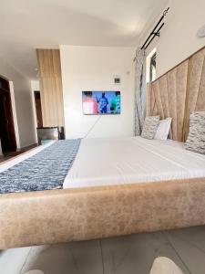 a bedroom with a large bed in a room at Kheyre Nyali Ocean View Two Bedrooms Apartments in Mombasa +48 photos