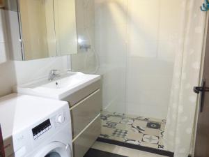 a bathroom with a sink and a washing machine at Appartement RDC rénové, 4 pers, climatisation - FR-1-475-209 in Saintes-Maries-de-la-Mer +3 photos