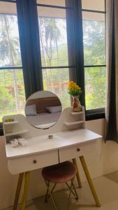 a white dressing table with a mirror and a chair at Marioo Apartment Koh Tao in Koh Tao +4 photos