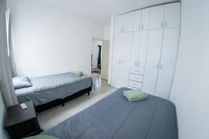 a bedroom with two beds and a dresser at Selva escondida in Puerto Morelos +55 photos