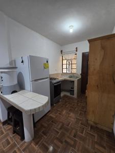 a kitchen with a white refrigerator and a counter at Casa Café in San Lucas Tolimán