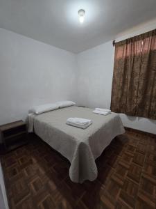 a bedroom with a bed with two towels on it at Casa Café in San Lucas Tolimán +4 photos