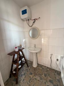 a bathroom with a sink and a mirror at Carpe Diem Nungwi in Nungwi