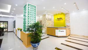 a lobby of a store with a potted plant at Hana 1 Apartment & Hotel Bac Ninh in Bắc Ninh