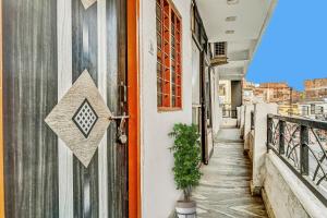 an alleyway with an orange door and a plant at SPOT ON Hotel Aman Palace in Bhopal