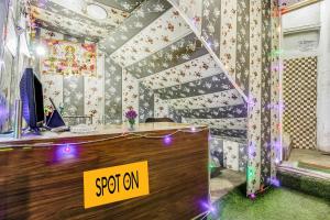 a room with a desk with a sign on it at SPOT ON Hotel Aman Palace in Bhopal
