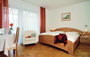 a bedroom with a bed and a table and a chair at Gasthof Weißes Lamm in Nuremberg