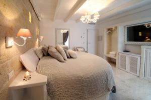 a bedroom with a bed with pillows on it at Playa del Mar - Adults Only in Monopoli