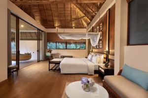 a hotel room with a bed and a living room at 98 Acres Resort & Spa in Ella +62 photos