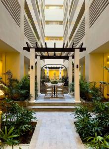 a patio with a table and chairs in a building at Opulent Spacious 3 BR Condominium at St Dominique at Megaworld in Iloilo City
