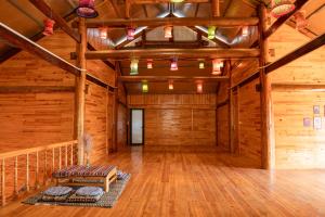 a large room with wooden walls and a wooden ceiling at Hmong Farmstay in Sapa