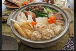 a bowl of food with meat and vegetables on a table at ホテル龍吉 in Misaki