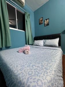 a bedroom with a bed with blue walls and a window at 1Br 2pax 1car only Malaysian guest only in Bayan Lepas