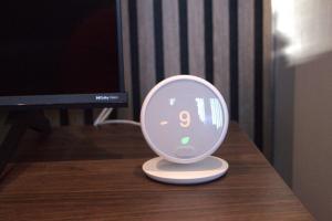 a alarm clock sitting on top of a table at Luxury 3 bedroom house in Harlow, Essex in Harlow