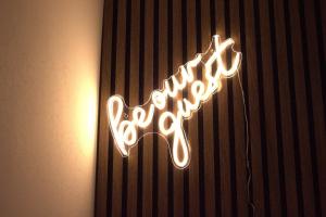 a neon sign that says recovery on a wall at Luxury 3 bedroom house in Harlow, Essex in Harlow