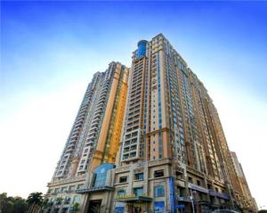 a tall building with many windows in a city at Fietser International Residence in Shenzhen