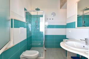 a bathroom with a shower and a toilet and a sink at Biriola EcoResort Cala Gonone in Cala Gonone