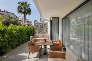 a patio with a table and chairs on a balcony at Wolf Suites in Antalya