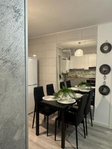 a dining room and kitchen with a table and chairs at Sara Suite in Sibiu +44 photos