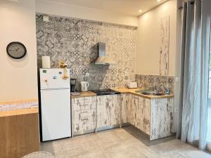 a kitchen with a refrigerator and a sink at Seaside Escape in Athens