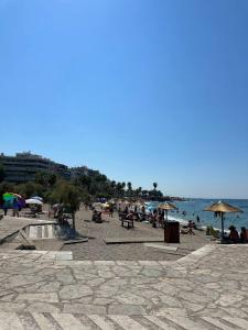 a group of people on a beach with umbrellas at Seaside Escape in Athens