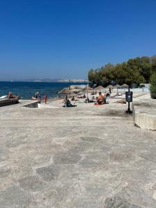 a group of people on a beach with umbrellas at Seaside Escape in Athens +5 photos