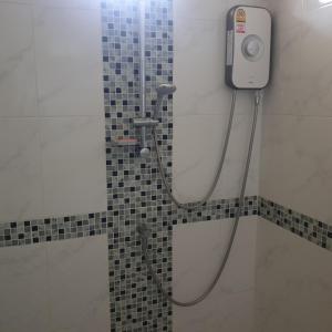 a bathroom with a shower with a camera on the wall at sengjan garden krabi in Ban Khlong Son