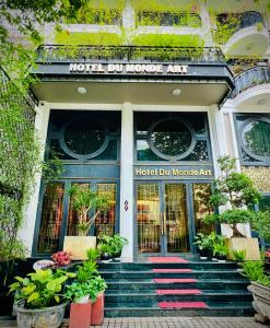 a hotel entrance with plants in front of it at Hotel du Monde Art in Hanoi
