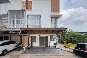 a house with a parking lot in front of it at Urbanview Hotel Syariah at Rihlah Homestay Batam in Kangboi