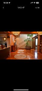 a living room with a tree in the middle of a room at BARi OKINAWA in Itoman