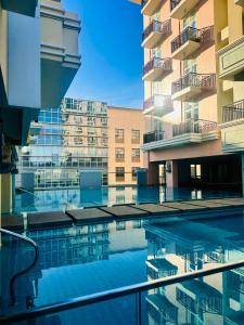 a view of a building from a swimming pool at Opulent Spacious 3 BR Condominium at St Dominique at Megaworld in Iloilo City