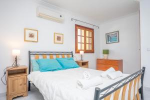 a bedroom with a large bed with blue pillows at Casa Judith in Muro +38 photos