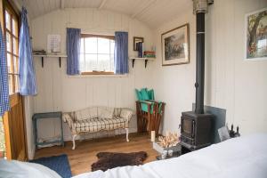 a living room with a stove in a room at Mollies Hut in Frome